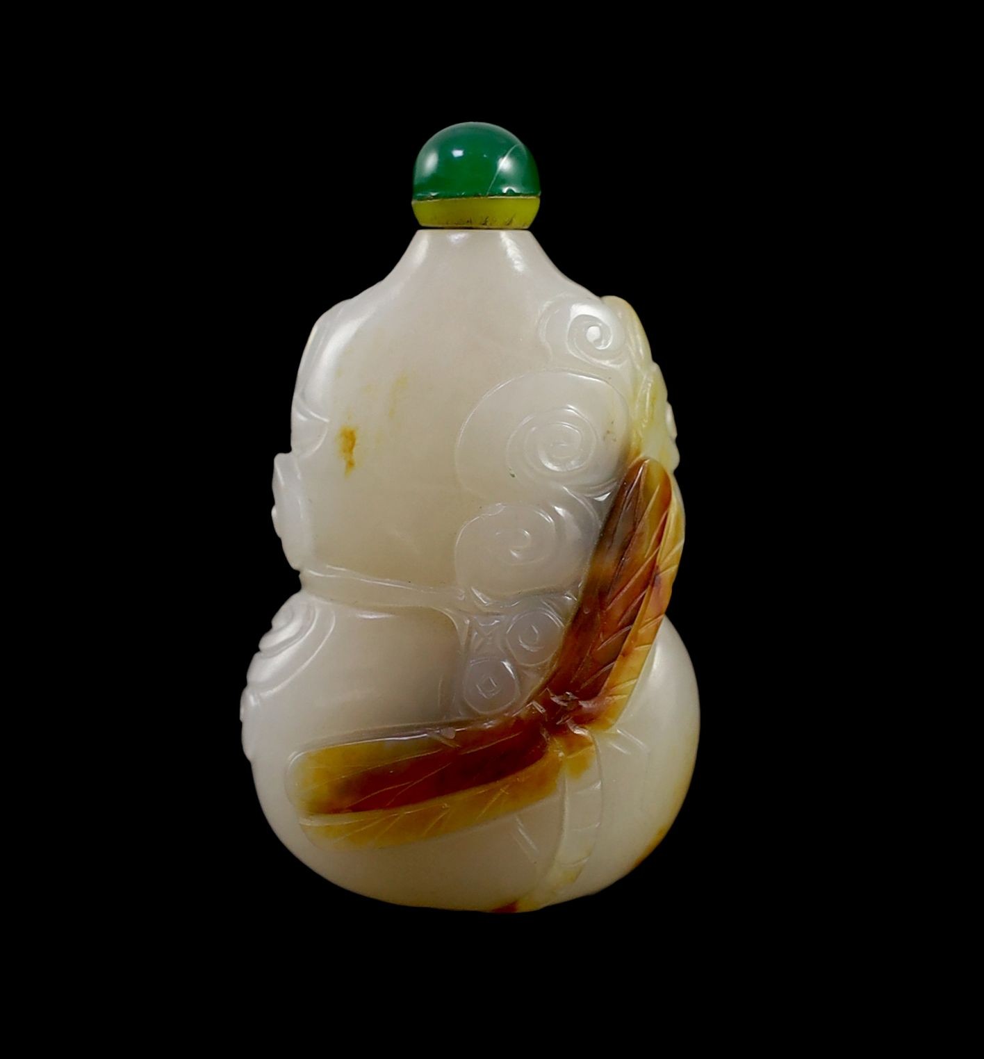 A Chinese white and russet jade snuff bottle, 19th century, 4.9 cm high excluding stopper